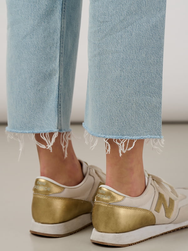 Raw hem and distressed straight leg jeans